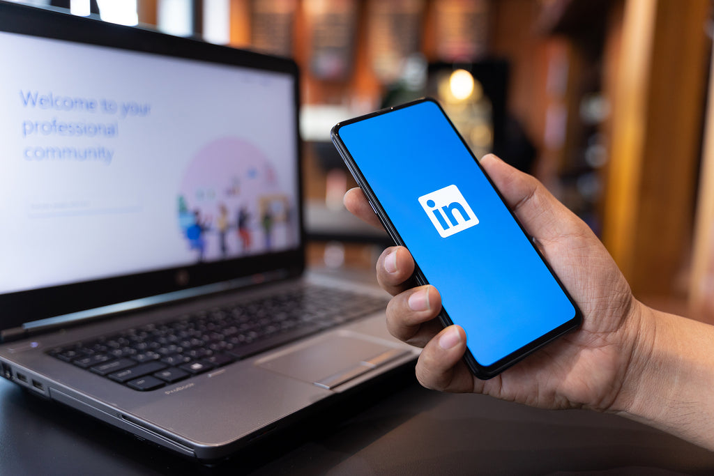 [UK] More than half of LinkedIn job ads fail to include salary - LinkedIn on mobile and laptop, UK LinkedIn ads missing pay details