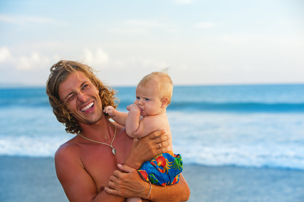 [Australia] Changes to unpaid parental leave requirements and employer action - father and baby son on the beach, parental leave Australia, key changes to unpaid parental leave